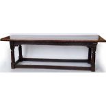 Oak refectory table, then plank top with breadboard ends raised on a carved frame and block and