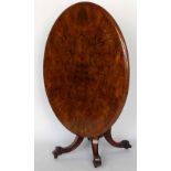 Victorian oval centre table, the figured walnut tip-top on a cluster column support and four out