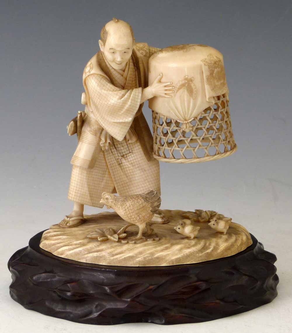 Japanese ivory okimono of a farmer holding a basket above a hen and chicks, Meiji period, signed