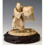 Japanese ivory okimono of a farmer holding a basket above a hen and chicks, Meiji period, signed