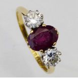 Boodle & Dunthorne 18ct gold and platinum three stone ruby and diamond ring, the oval stone +/- 8.44