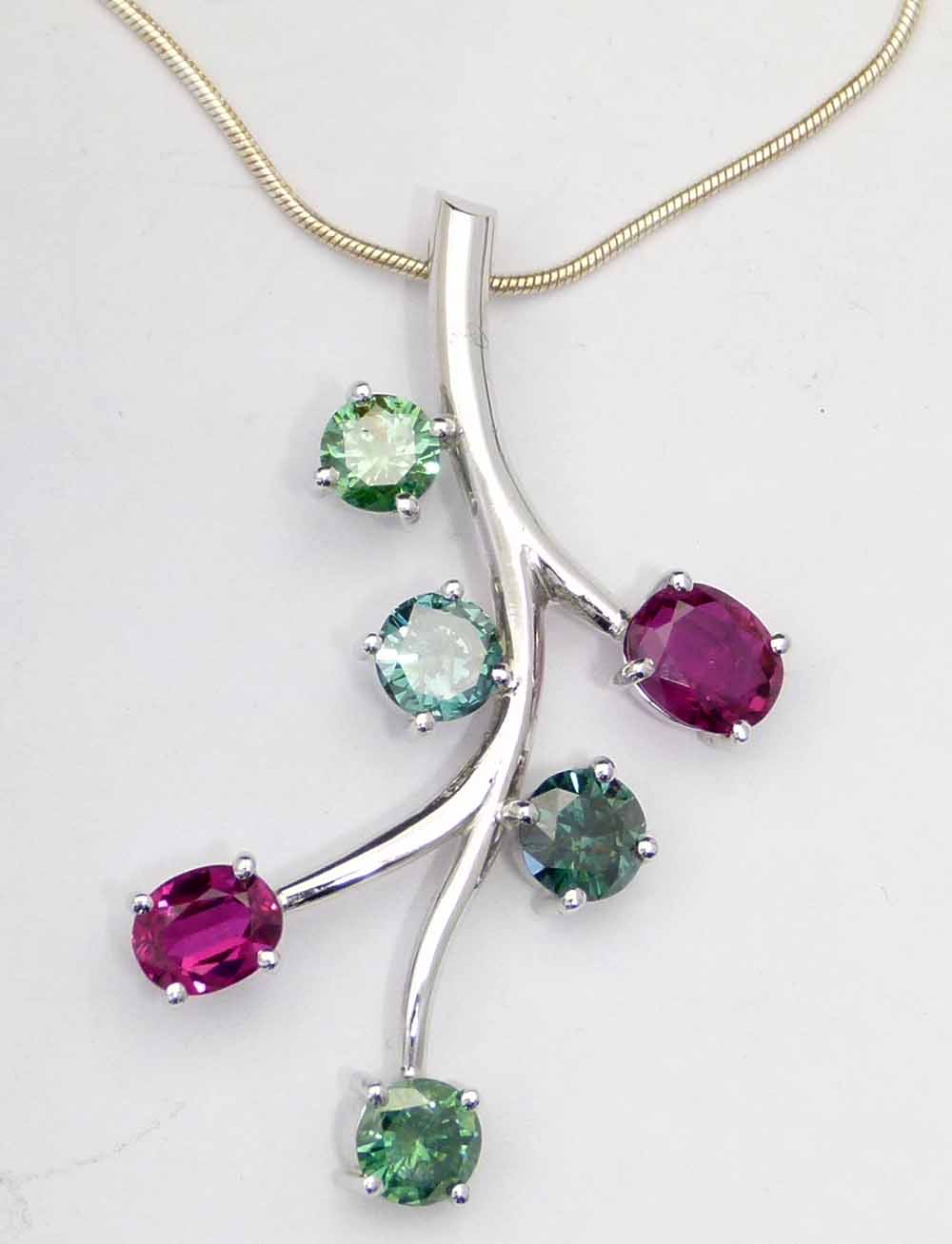 Ruby and green diamond (irradiated) floral spray pendant of unmarked white gold, length 45mm, on