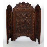 A Kashmir three-fold hardwood fire screen, carved with foliage, height 111cm.