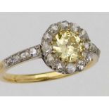 Natural fancy yellow diamond cluster ring, the central brilliant 0.71ct, surrounded by a border of