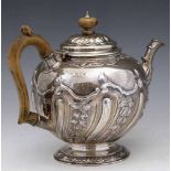 Embossed silver globular teapot London 1908, with wooden handle and knop, 24oz 19dwt gross.