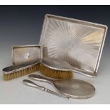 Silver dressing table set, Finnigans, London 1916 - 1924, of a hand mirror, two brushes, button hook