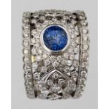White gold (unmarked) sapphire and diamond ring, the central coloured stone on an openwork broad
