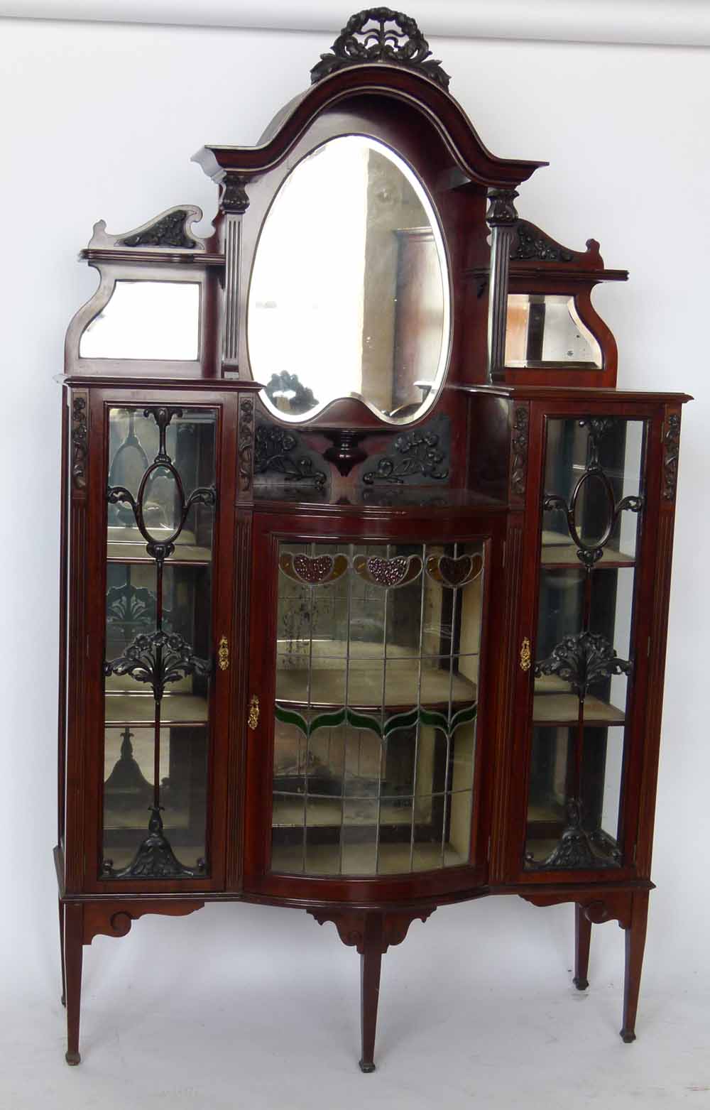 Late Victorian mahogany display cabinet with a canopied mirror back, width 123cm.