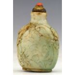 Jade snuff bottle, 18th century, the greenish body carved on either side with a fire -breathing