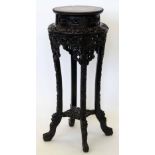 Chinese carved hardwood jardiniere stand with an inset red marble top, height 86cm.
 
Condition