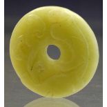 Chinese green jade bi (holed disc) carved with a dragon and ruyi, diameter 5cm.     Condition