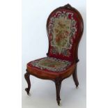 Victorian rosewood show frame nursery chair with a high beadwork back.