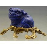 Lapis lazuli carved figure of a crouching Lion of Fo, on a French bronze scrolled stand, overall