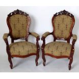 Pair of Victorian mahogany show-frame open arm upholstered drawing room chairs.