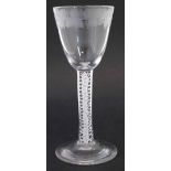 Wine glass, the bowl engraved with grapes and leaves, above opaque twist stem, on slightly raised