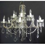 Glass chandelier  with six branches decorated with flower heads and a cut glass droppers, shields