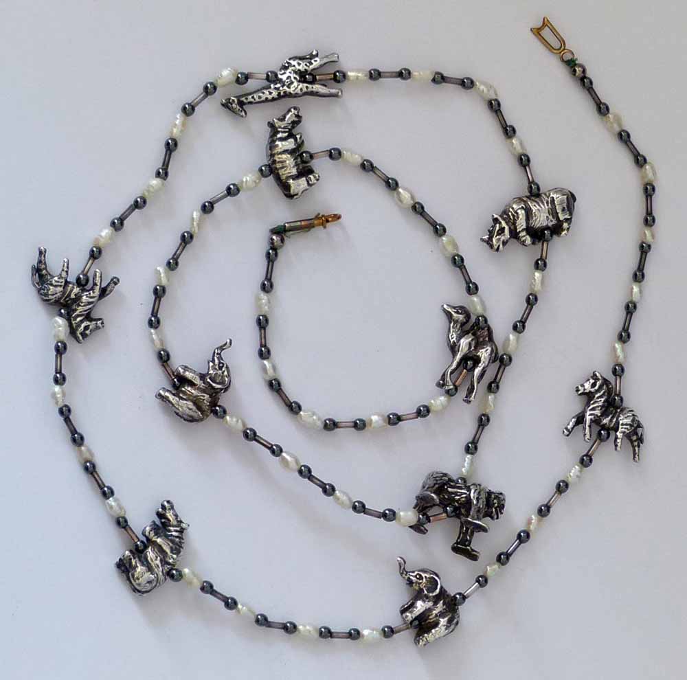Necklace set with ten African animal models interspersed by baroque pearls and black beads, length