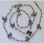 Necklace set with ten African animal models interspersed by baroque pearls and black beads, length