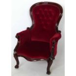 Victorian mahogany spoon back arm chair upholstered in red velvet.