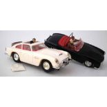 Scalextric James Bond pair of Cars, white Aston Martin DB4 with bullet proof shield, sunroof and