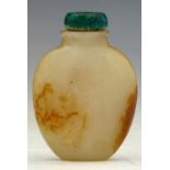 Russet and white jade snuff bottle the flattened body carved along the sides with bamboo, green