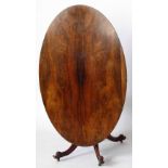 Victorian rosewood oval centre table, the tip top on four outswept legs, length 160cm.