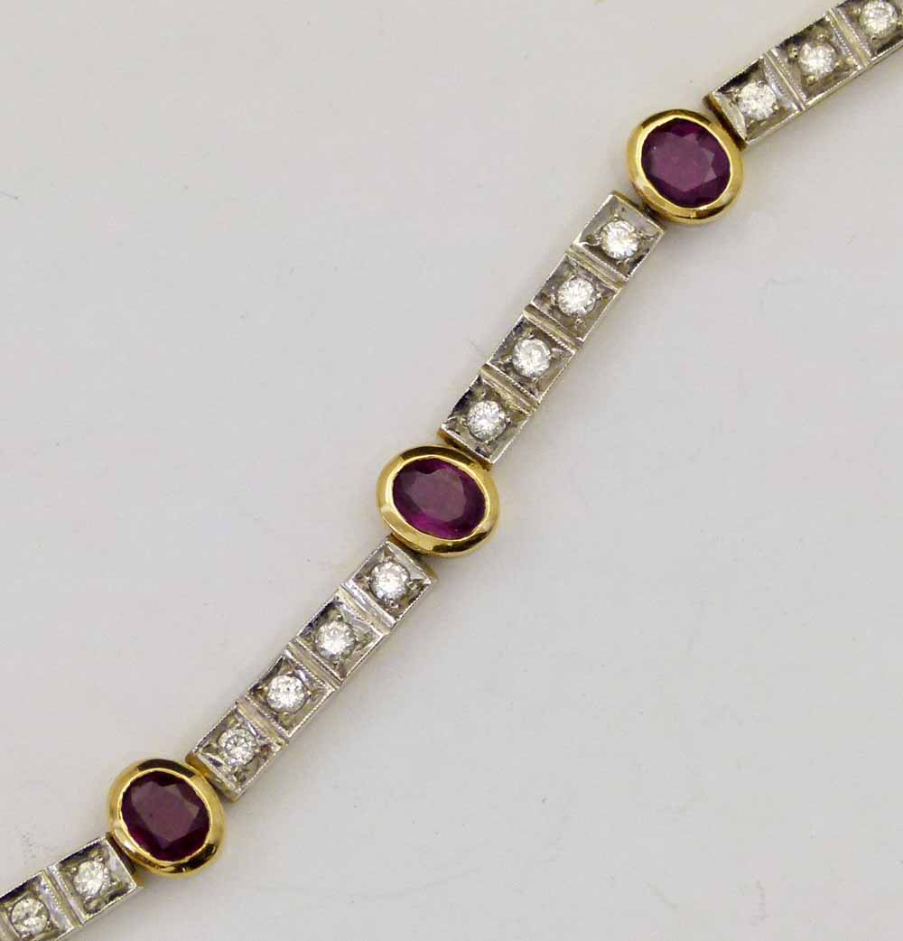 Italian 750 ruby and diamond line bracelet of seven oval rubies interspersed by blocks of four