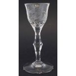 Wine glass circa 1800 the bowl engraved with exotic birds and flowers, facetted stem and shaped