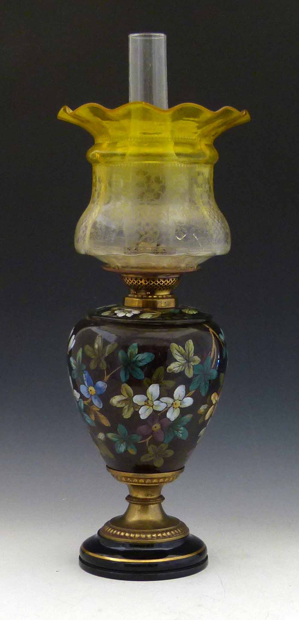 Victorian floral pottery oil lamp, height to burner 37cm, with yellow glass shade.
 
Condition