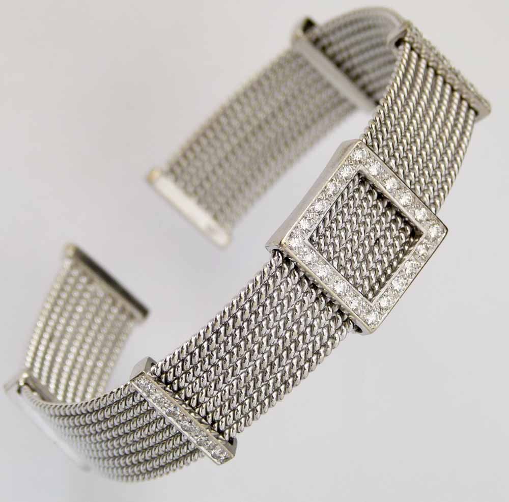 White gold (750) mesh bangle set at intervals with channels of brilliant diamonds, gross weight 35.