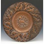 John Pearson, 1892, (fl.1885 - 1910) an embossed copper charger, the well decorated with a