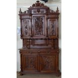 French Louis XIII style carved walnut cabinet, the upper part of three doors, over two drawers and