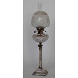 Electro plated Corinthian column table oil lamp with a cut glass reservoir and etched glass shade,