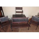 Cast metal garden furniture with lattice work back complete with table; bench; two chairs and