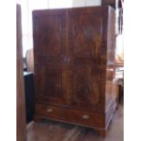 Inlaid mahogany two-door wardrobe or press fitted later with shelves, on drawer base, width 132cm.