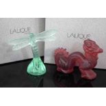 Two boxed Lalique models, to include a green tinted dragonfly, 8cm high and a red tinted Chinese