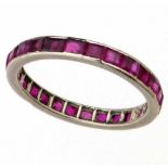 Unmarked platinum and ruby eternity ring, circa 1930, ring size Q, gross weight 2.8g.