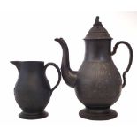 Black basalt coffee pot, moulded with figures dancing either side of the Prince of Wales feathers,