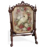 Victorian mahogany cheval firescreen, the carved frame enclosing a stump work cockatoo, height