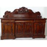 Victorian mahogany sideboard, the scrolled back over three apron drawers and four doors, length