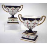 Pair of Minton twin handled vases, each mounted on square pedestals, painted with roses, (2) 12cm