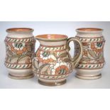 Pair of Crown Ducal Charlotte Rhead vases and a ewer, decorated with tube lined floral patterns,