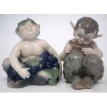 Two Royal Copenhagen Fauns, one modelled sat amongst grapes, the other playing the pipes, models