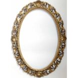 Oval gilt wood frame carved with leaves, 92cm x 66cm overall.