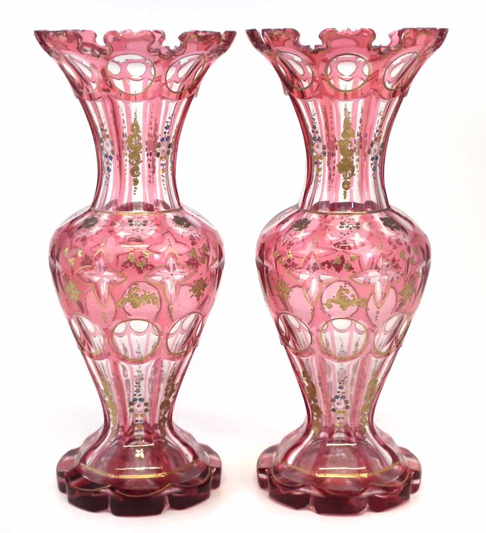 Pair of mid 19th century Bohemian glass vases, with red cut through panels, decorated with gilt