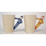 Two Clarice Cliff Gnome ware beakers, with pixie handles, printed marks to base, (2) 9cm high