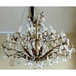 Gilt metal chandelier of twelve branches hung with glass briolettes.