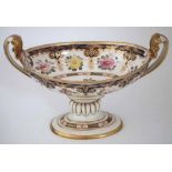 English porcelain twin handled table centre, with twin handles, painted with flora on gilt scrolls