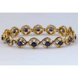Sapphire and diamond bracelet, the circular links each set with an oval sapphire interspersed by