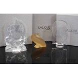 Three Lalique boxed models, to include a figure of Ganesh, an amber tinted duck and a Mascot moulded